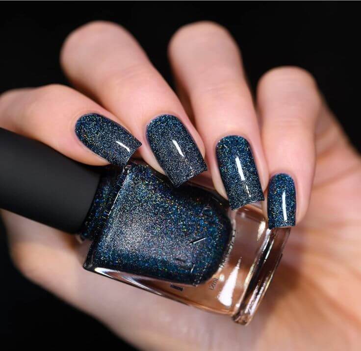 Dark Blue: The Must-Have Nail Polish for Every Season 3. ILNP Nail Polish in Skyline  Glittering dark blue is suitable for all-season themes without being trite. It can also be a bold yet classic excellent choice for those who find it difficult to match dark colors.
ILNP Skyline - Midnight Sapphire Blue Ultra Holo Nail Polish