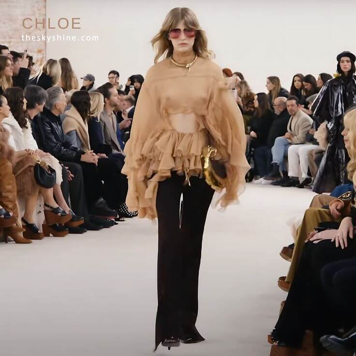 Sustainable Style: Chloé’s Fall Winter 2024 Blouse 2. Cutout Ruffled Silk-Crepon Turtleneck Blouse This blouse is a must-have for those looking to make a stylish bohemian choice this season. 
CHLOE Cutout Ruffled Silk-Crepon Turtleneck Blouse